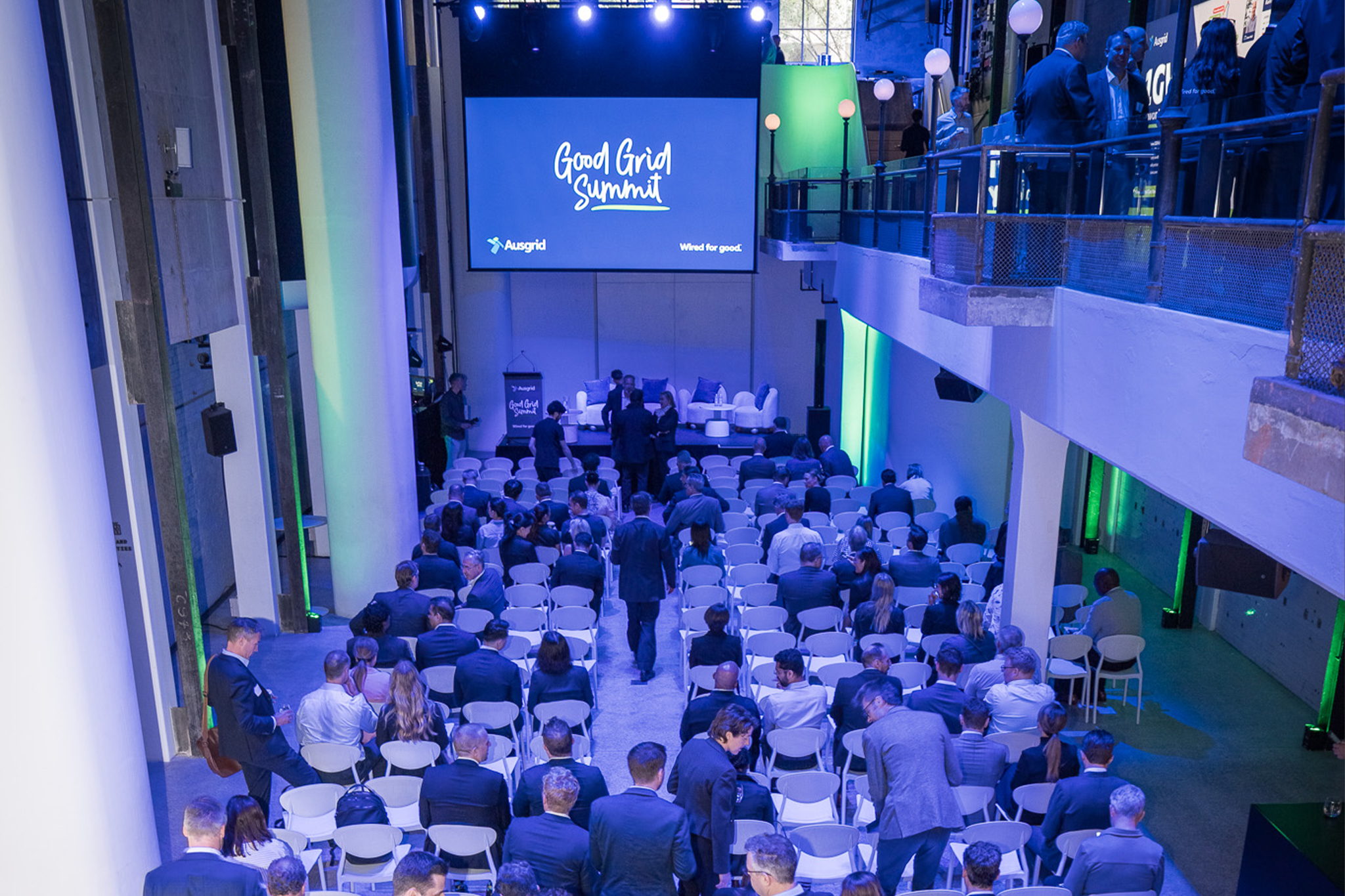 Good Grid Summit 2025 crowd sitting down in front of large projector screen